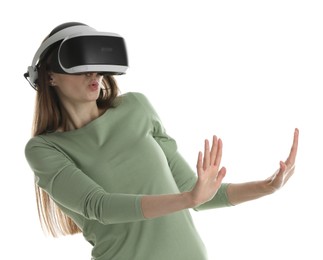 Photo of Surprised woman using virtual reality headset on white background