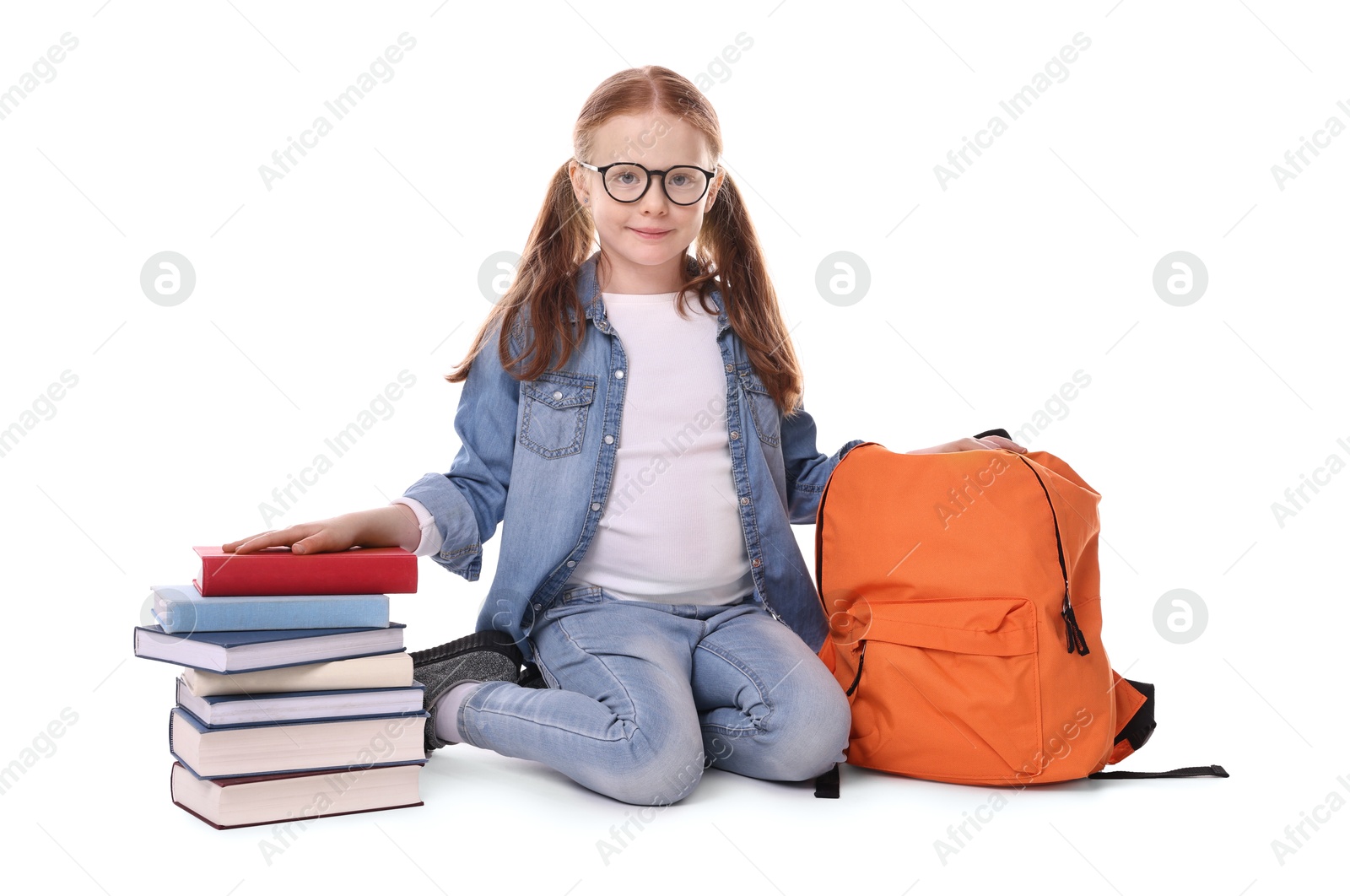 Photo of Cute little girl with stack of books and backpack on white background