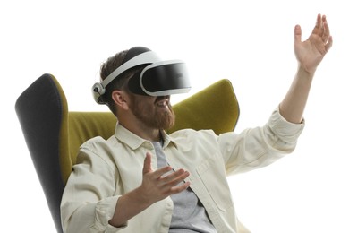 Photo of Smiling man using virtual reality headset while sitting in armchair on white background