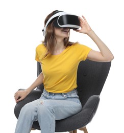 Photo of Smiling woman using virtual reality headset while sitting in armchair against white background