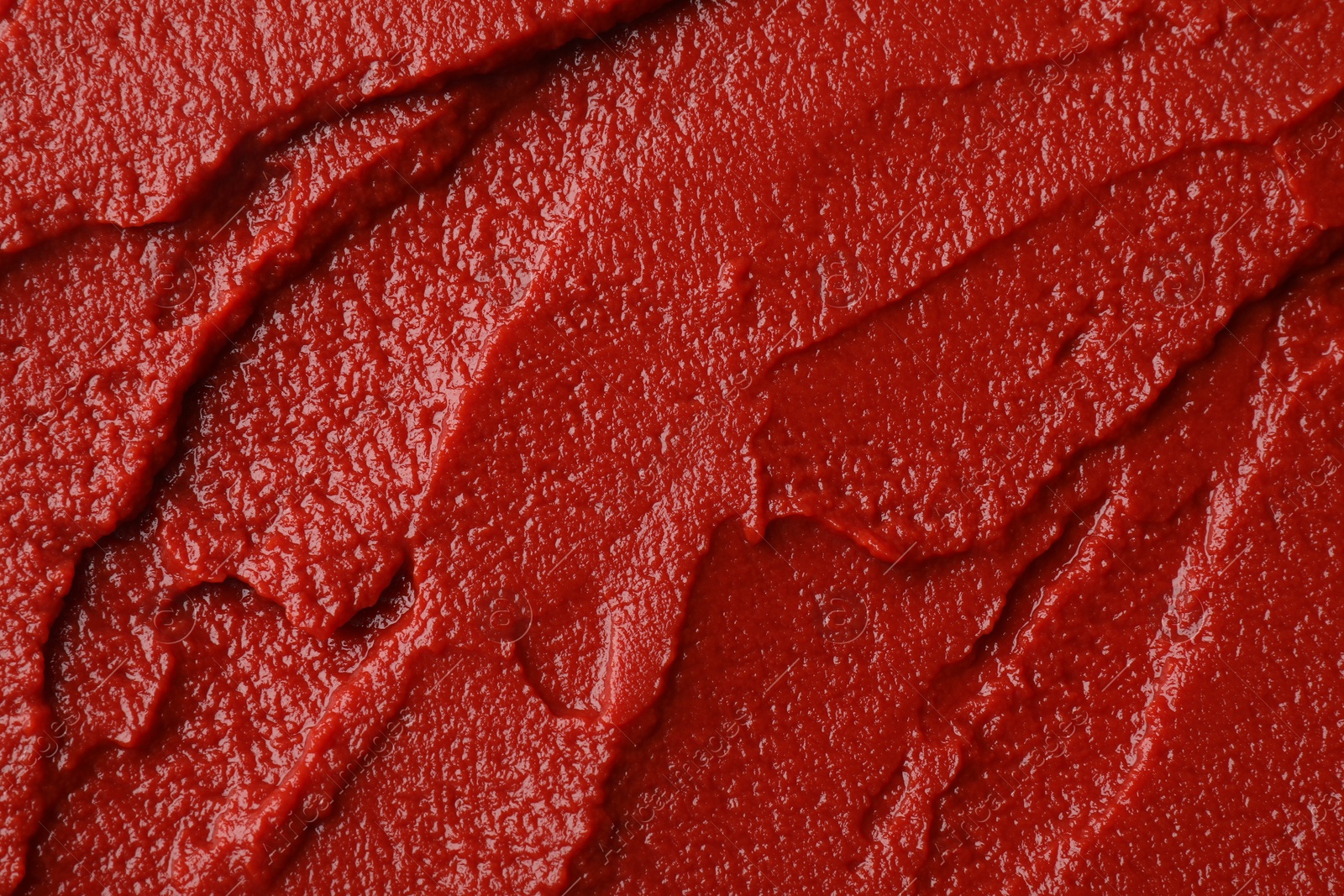 Photo of Texture of ketchup as background, top view. Tomato sauce