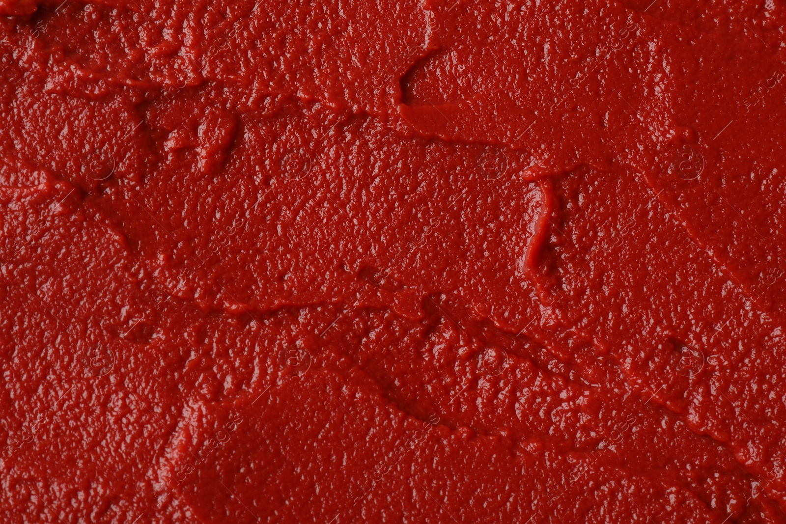 Photo of Texture of ketchup as background, top view. Tomato sauce