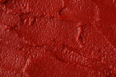 Photo of Texture of ketchup as background, top view. Tomato sauce