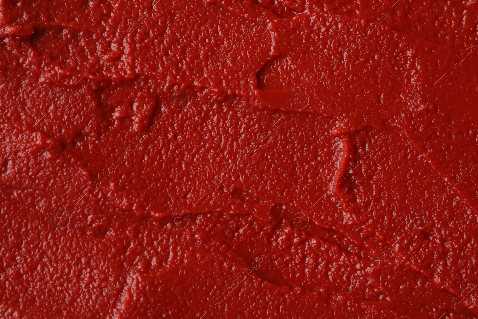 Photo of Texture of ketchup as background, top view. Tomato sauce