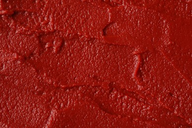 Photo of Texture of ketchup as background, top view. Tomato sauce