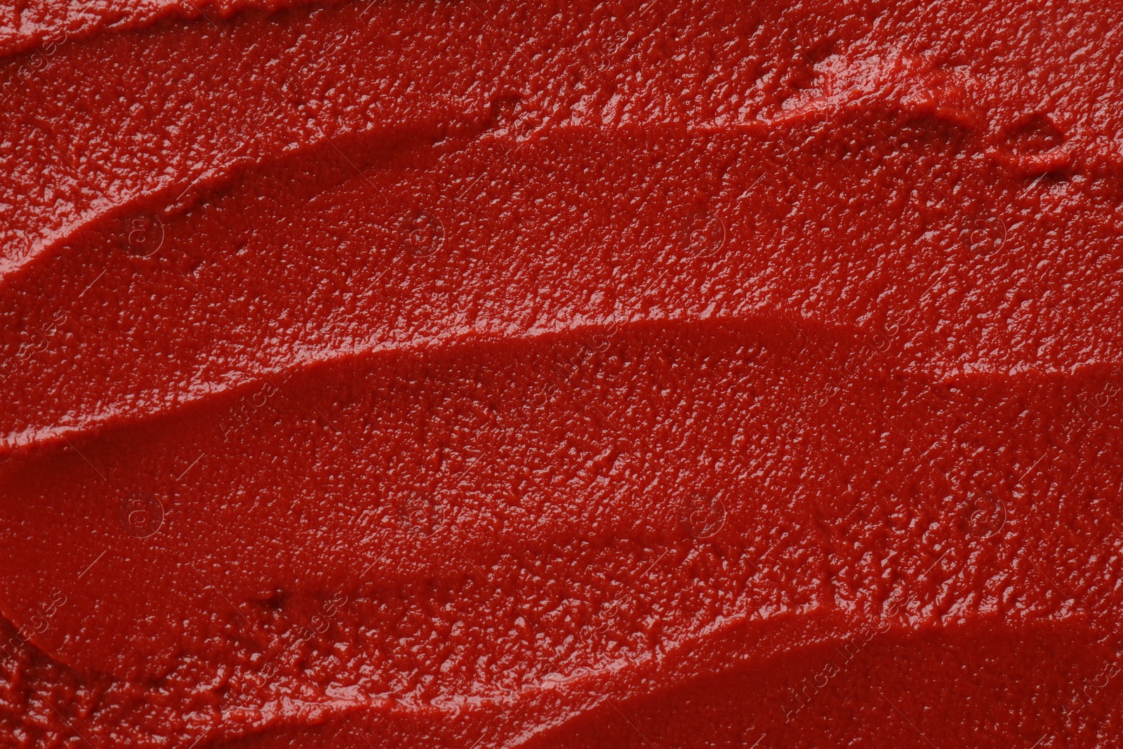 Photo of Texture of ketchup as background, top view. Tomato sauce