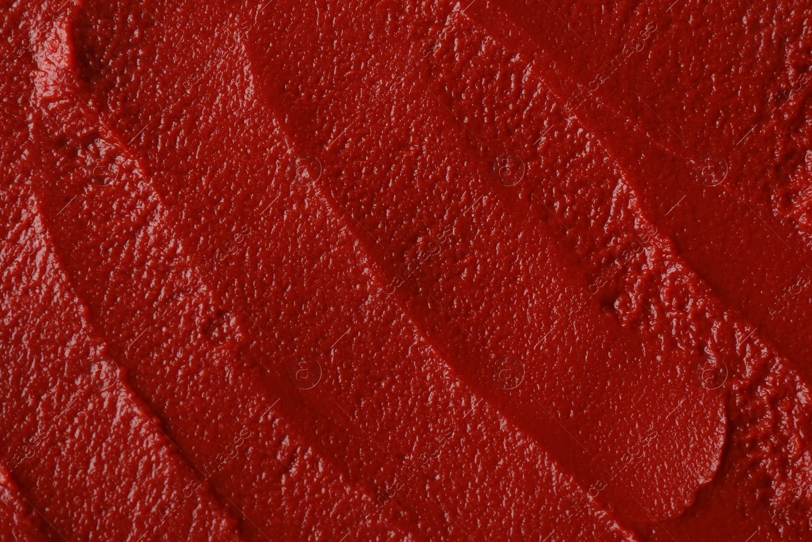 Photo of Texture of ketchup as background, top view. Tomato sauce