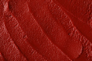 Photo of Texture of ketchup as background, top view. Tomato sauce