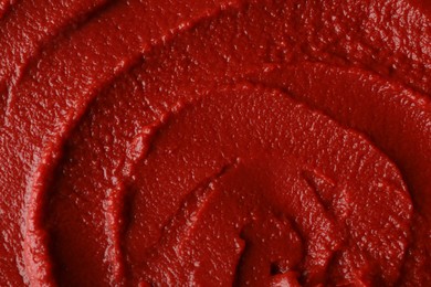 Photo of Texture of ketchup as background, top view. Tomato sauce