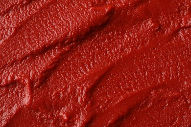 Photo of Texture of ketchup as background, top view. Tomato sauce