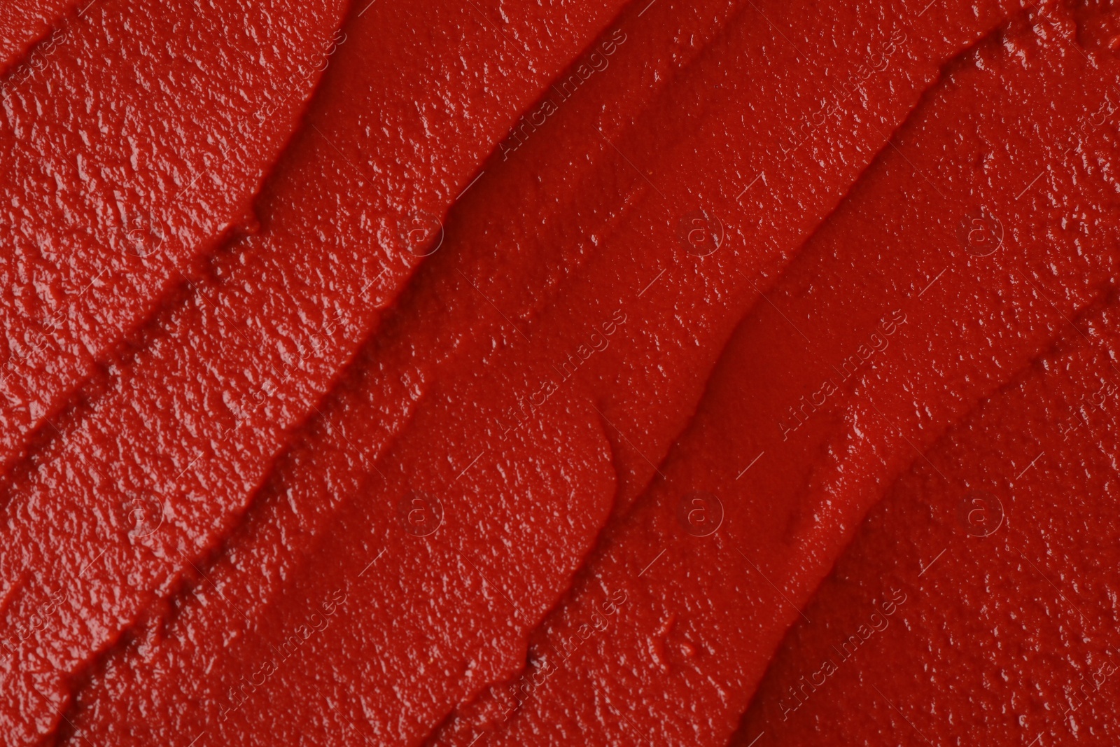 Photo of Texture of ketchup as background, top view. Tomato sauce