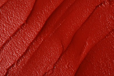 Photo of Texture of ketchup as background, top view. Tomato sauce