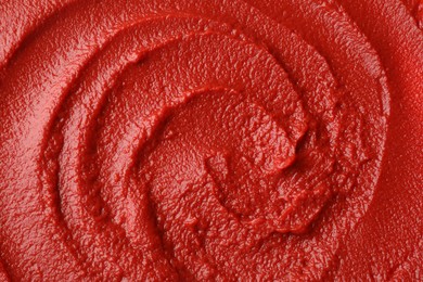 Photo of Texture of ketchup as background, top view. Tomato sauce