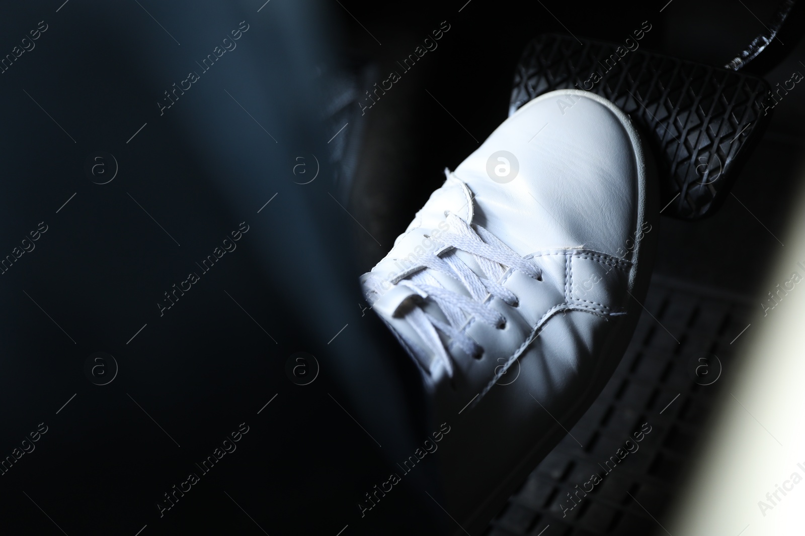 Photo of Man pushing on pedal of car brake, closeup