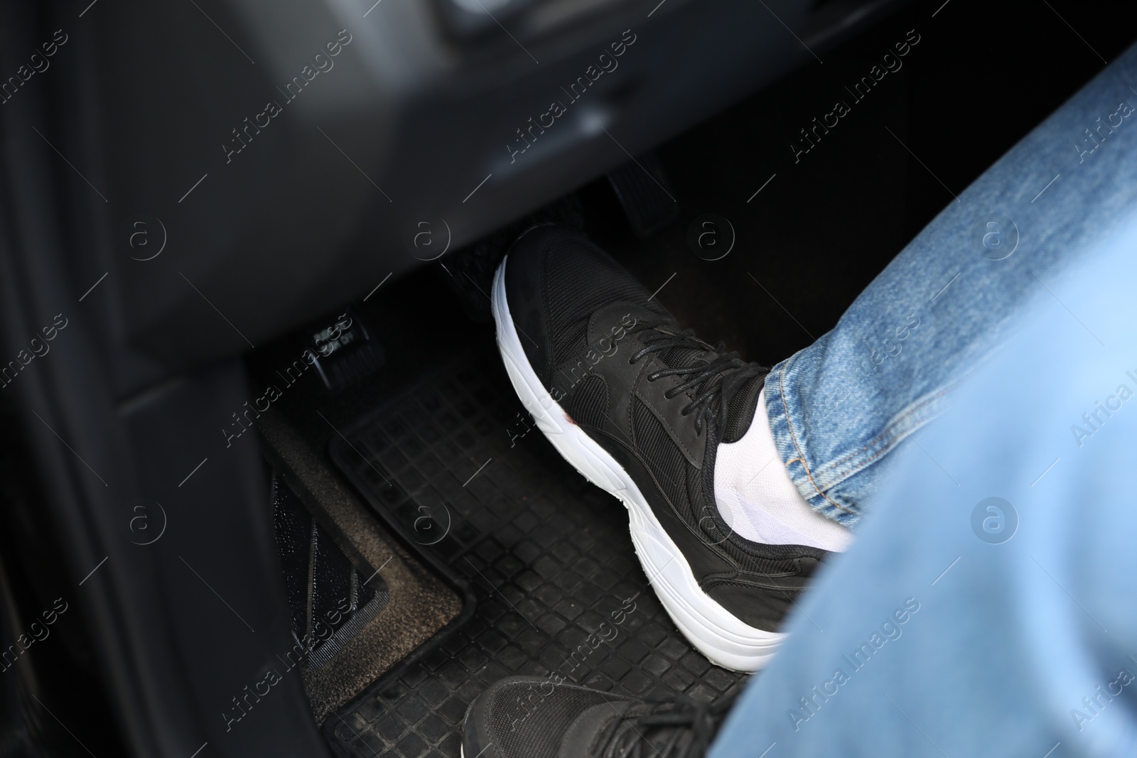 Photo of Man pushing on pedal of car brake, closeup