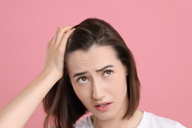 Photo of Sad woman with hair loss problem on pink background, closeup