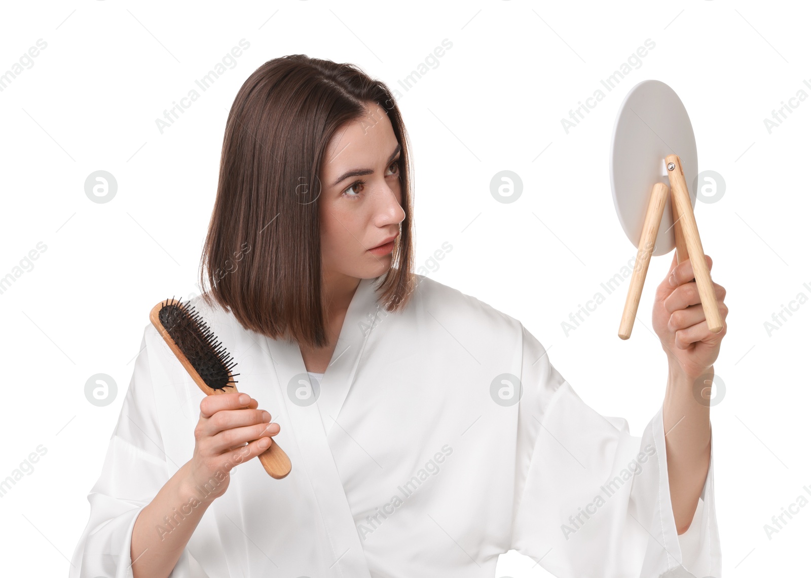 Photo of Young woman with hair loss problem looking at mirror on white background