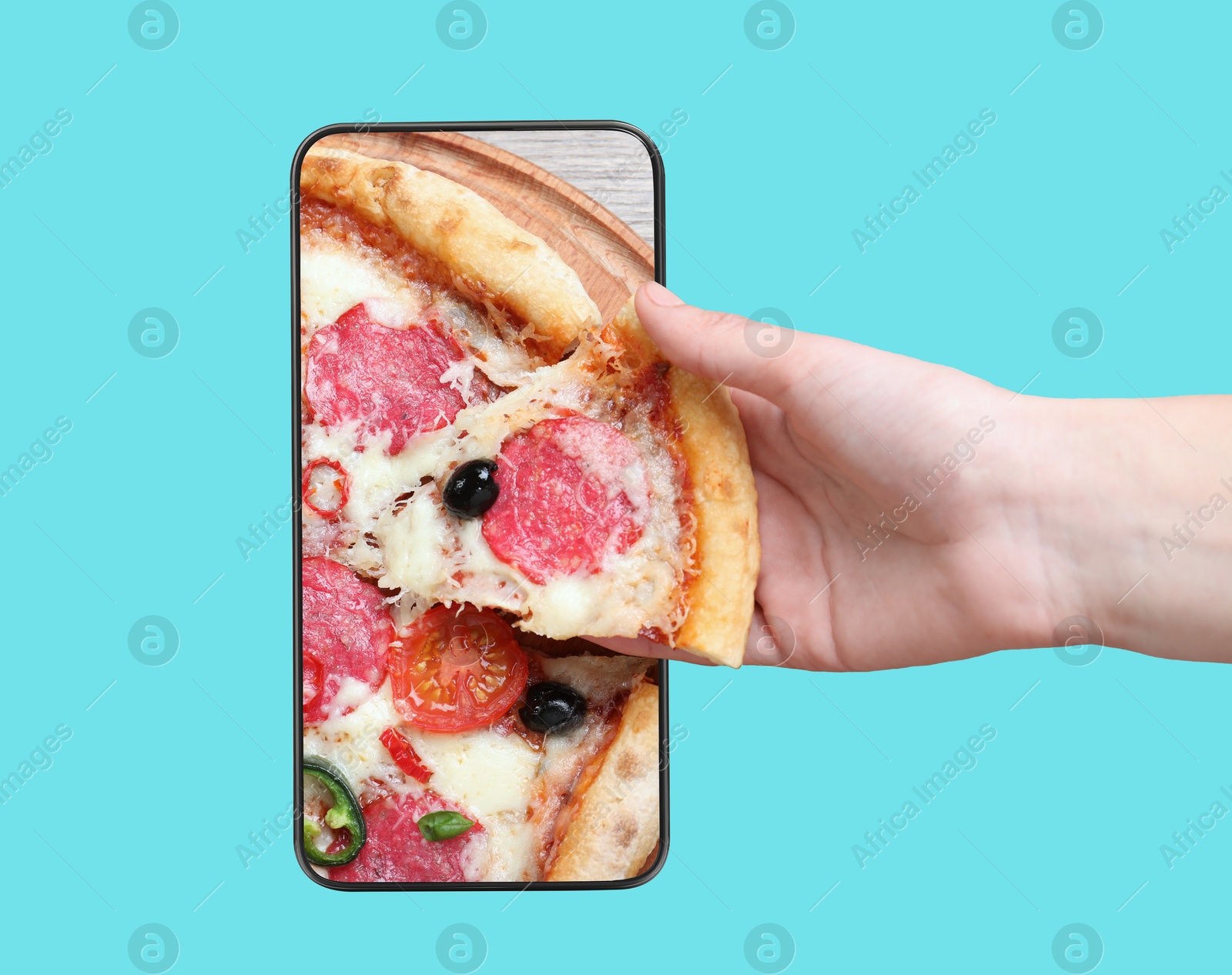 Image of Online food ordering. Woman taking slice of pizza from smartphone screen against light blue background, closeup