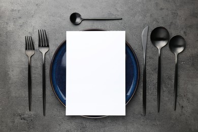 Empty menu, plate, cutlery and dry spike on grey table, flat lay. Mockup for design