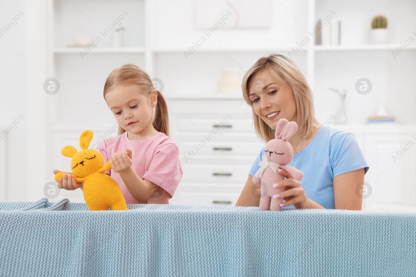 Photo of Puppet theatre. Mother and daughter performing show at home