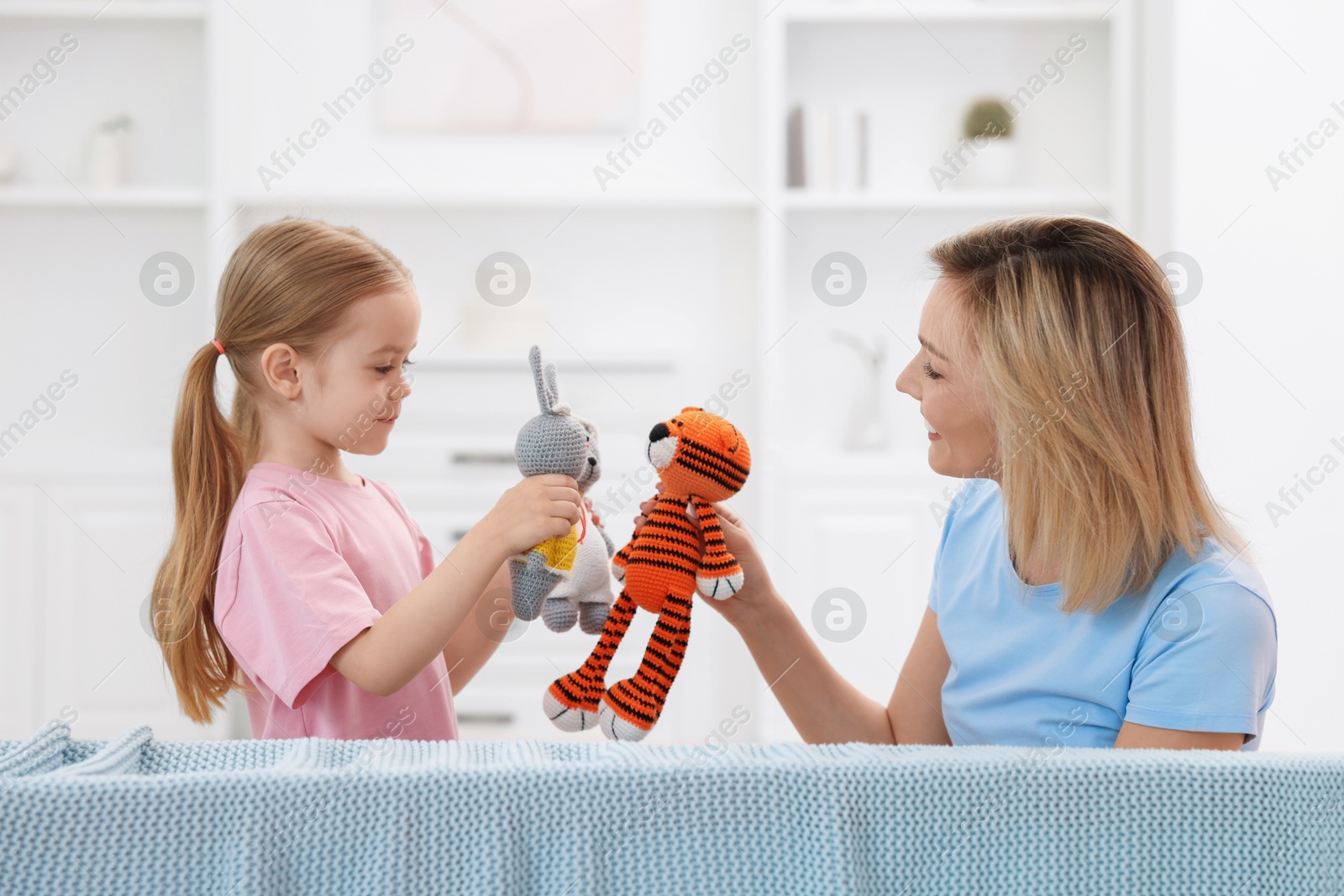 Photo of Puppet theatre. Mother and daughter performing show at home