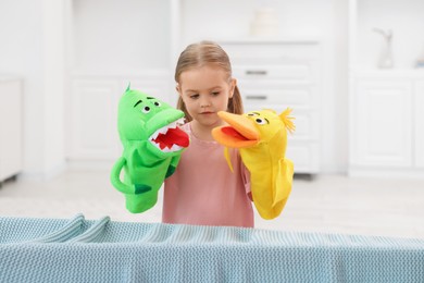 Puppet theatre. Cute girl performing show with toys at home