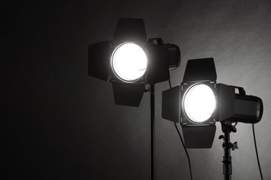 Dark photo background and professional lighting equipment in studio