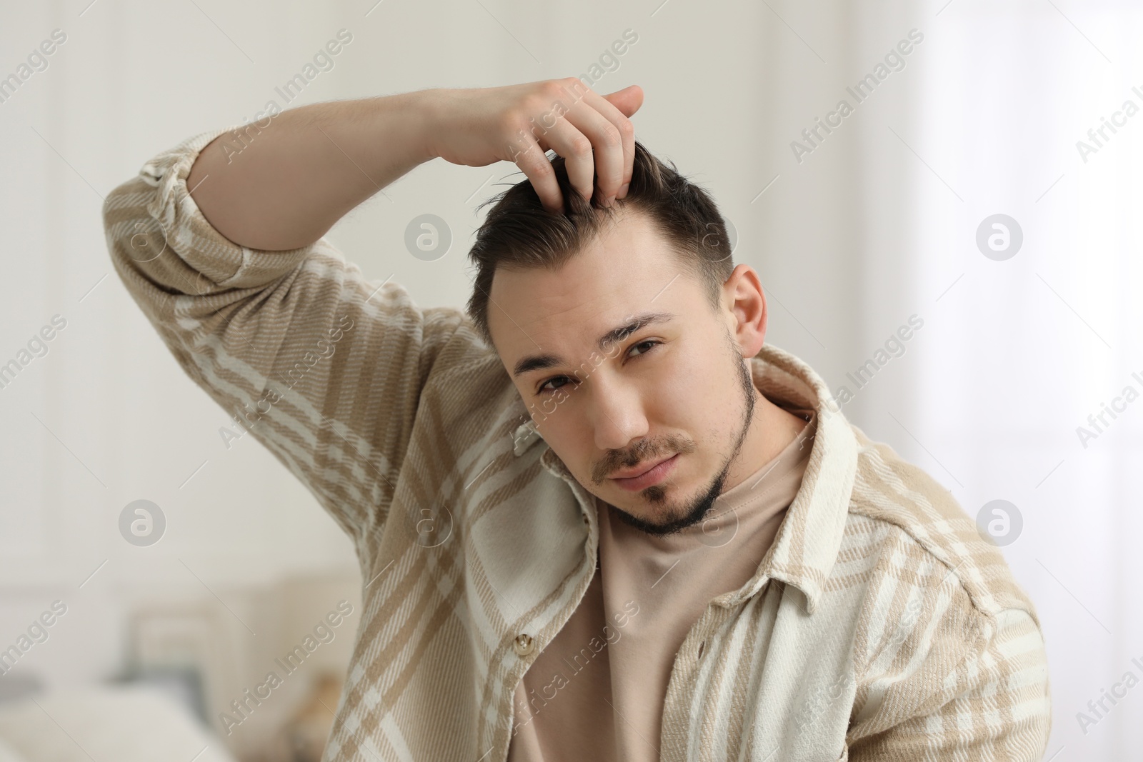 Photo of Baldness concept. Sad man with receding hairline indoors