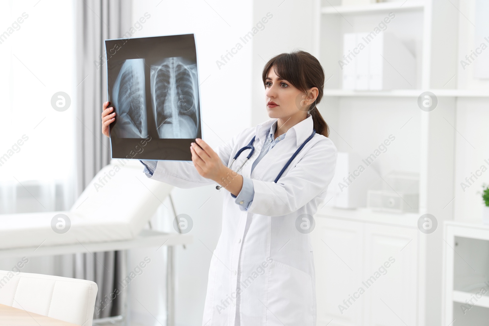 Photo of Lung disease. Doctor examining chest x-ray in clinic