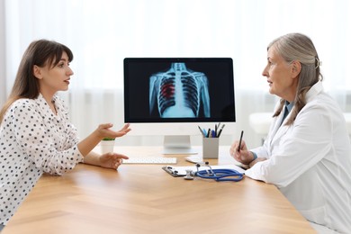 Photo of Lung cancer. Doctor discussing with her patient in clinic