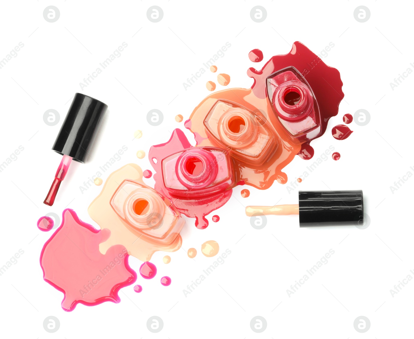 Photo of Many bottles, brushes and drops of colorful nail polishes isolated on white, top view