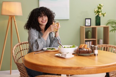 Woman having vegetarian meal at table in cafe