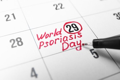 International Psoriasis Day. Calendar page with marked date and marker, closeup