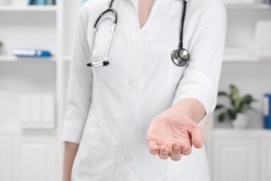 Doctor holding something in clinic, closeup view