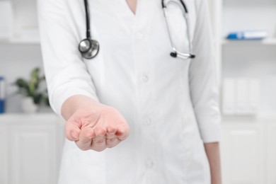 Photo of Doctor holding something in clinic, closeup view