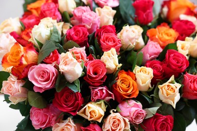 Bouquet of beautiful roses on light grey background, closeup