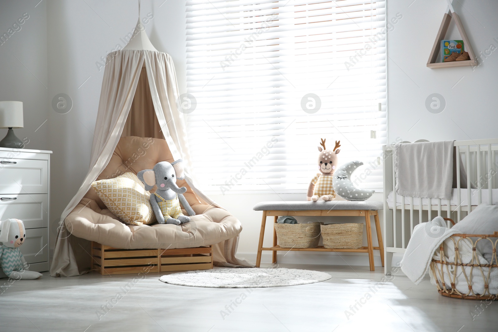 Photo of Comfortable armchair in modern baby room interior