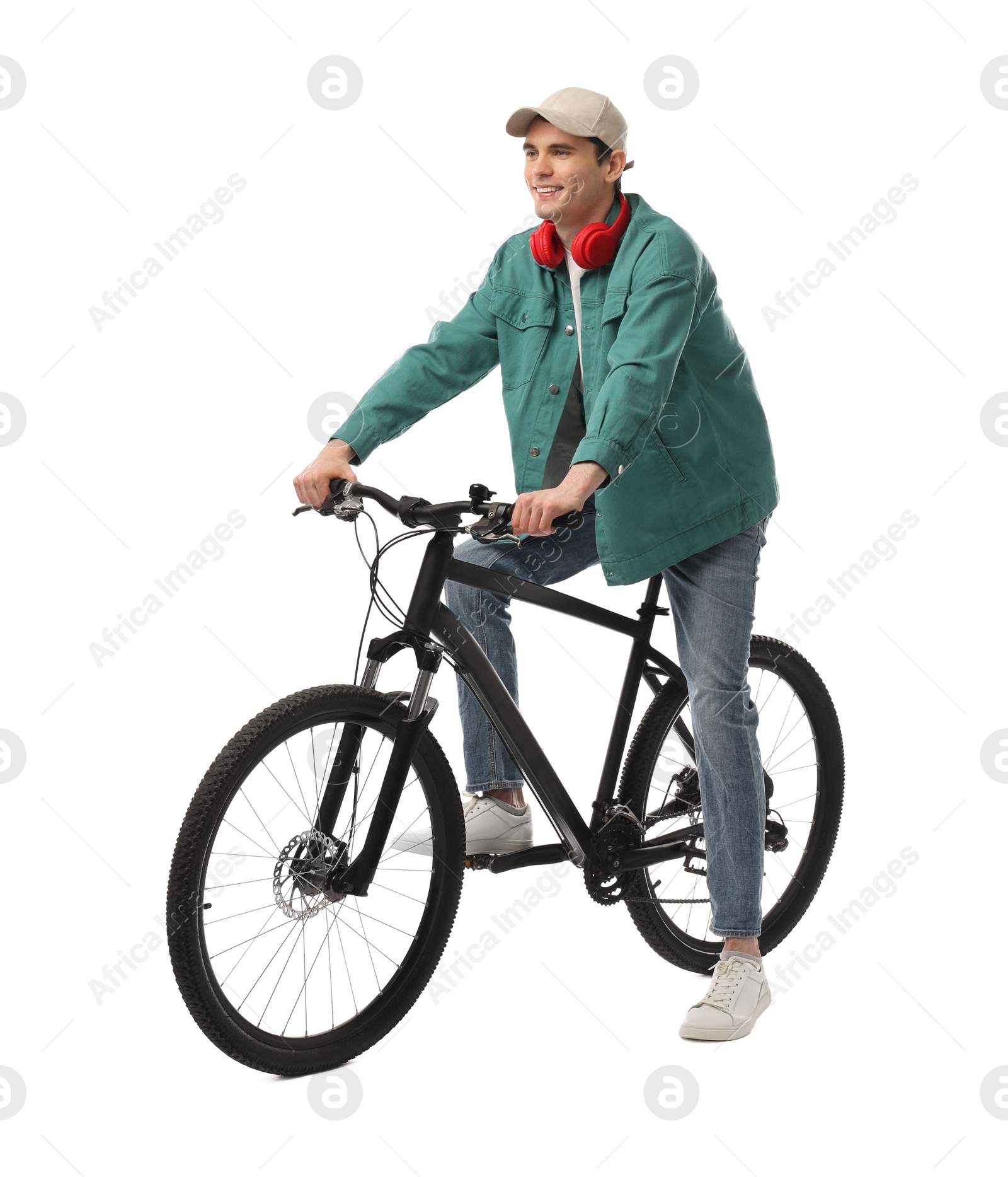 Photo of Smiling man with headphones on bicycle against white background