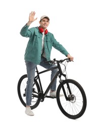 Photo of Smiling man with headphones on bicycle against white background