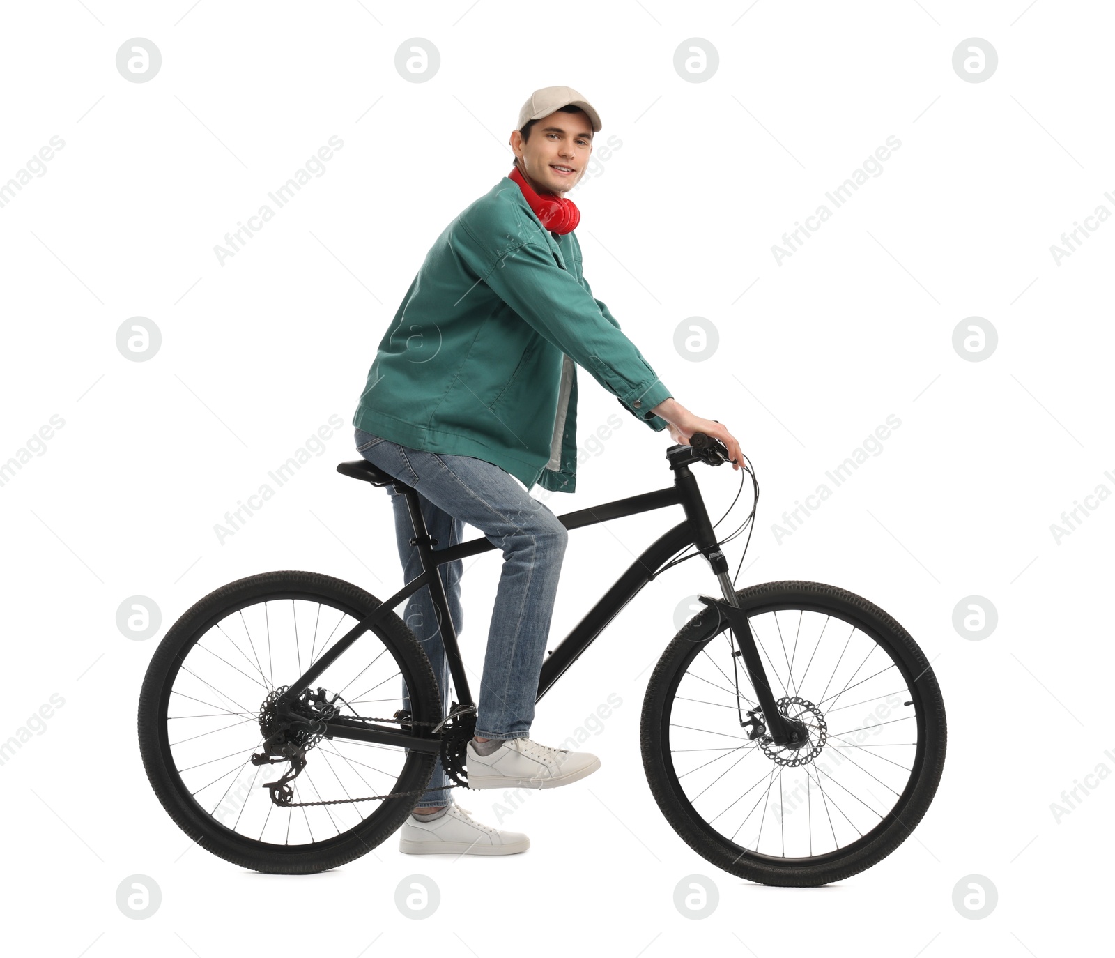 Photo of Man with headphones riding bicycle on white background