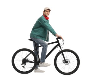 Man with headphones riding bicycle on white background
