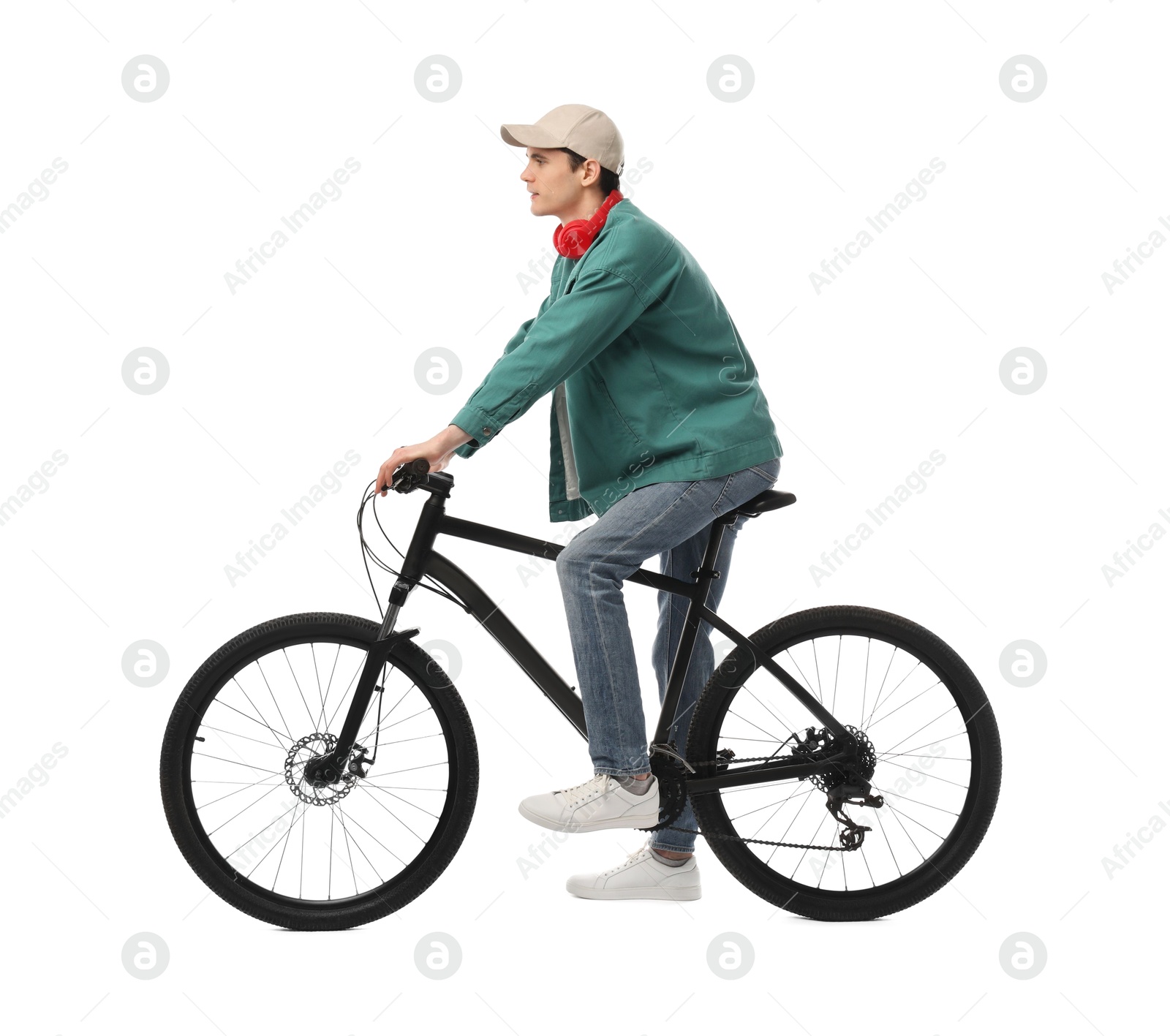 Photo of Man with headphones riding bicycle on white background