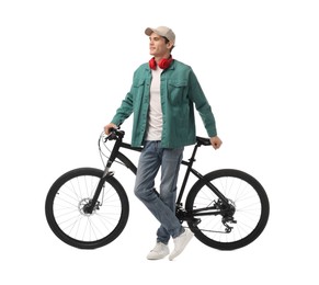 Smiling man with headphones near bicycle isolated on white