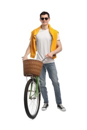 Photo of Smiling man in sunglasses near bicycle with basket isolated on white