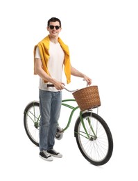 Smiling man in sunglasses near bicycle with basket isolated on white