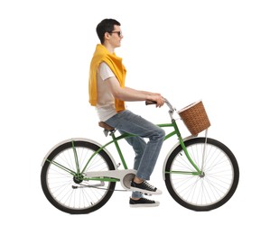Man in sunglasses riding bicycle with basket on white background