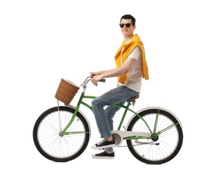 Smiling man in sunglasses riding bicycle with basket on white background