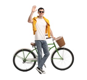 Smiling man in sunglasses near bicycle with basket isolated on white
