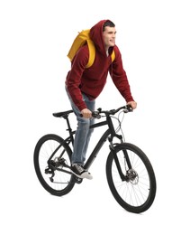 Smiling man with backpack riding bicycle on white background