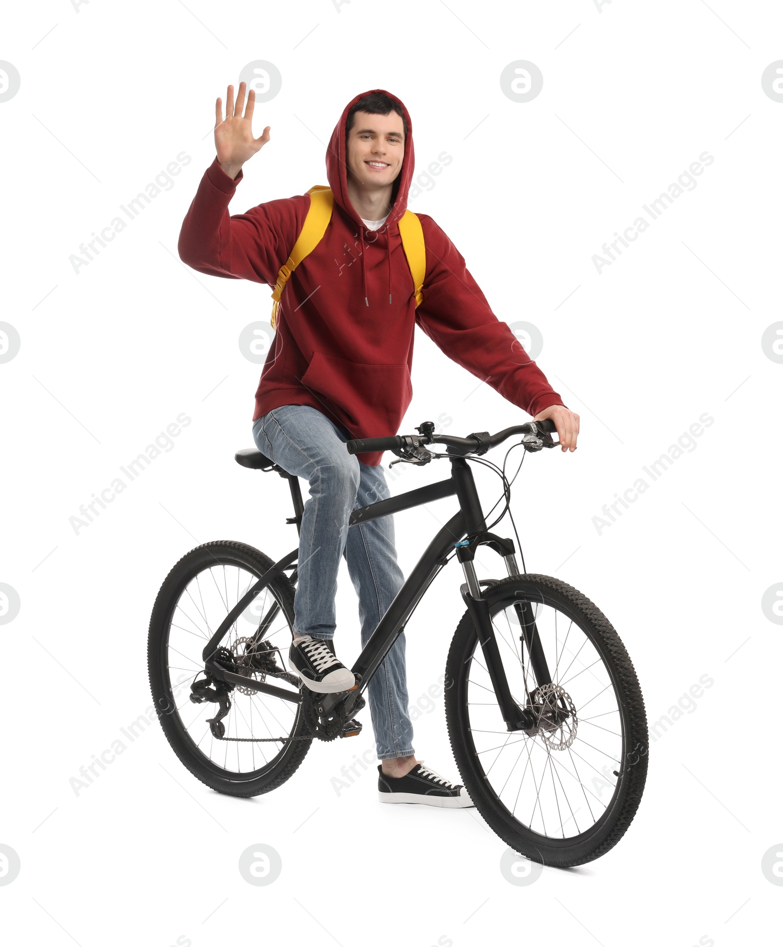 Photo of Smiling man with backpack on bicycle against white background
